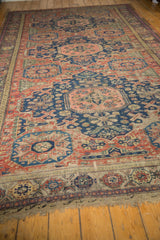 Antique Soumac carpet's intact wave stripe border, floral elements, and secured fringe.