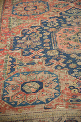 Intricate geometric patterns and hand-woven Soumac texture in dusty brick red and navy blue.