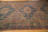 Antique Caucasian Soumac carpet section, dusty red and navy geometrics with border details.