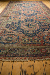 Fringed geometric wave border on an antique Soumac carpet, showing exposed foundation.