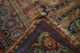 Antique Caucasian Soumac carpet detail, displaying geometric patterns, woven pile, and exposed foundation.