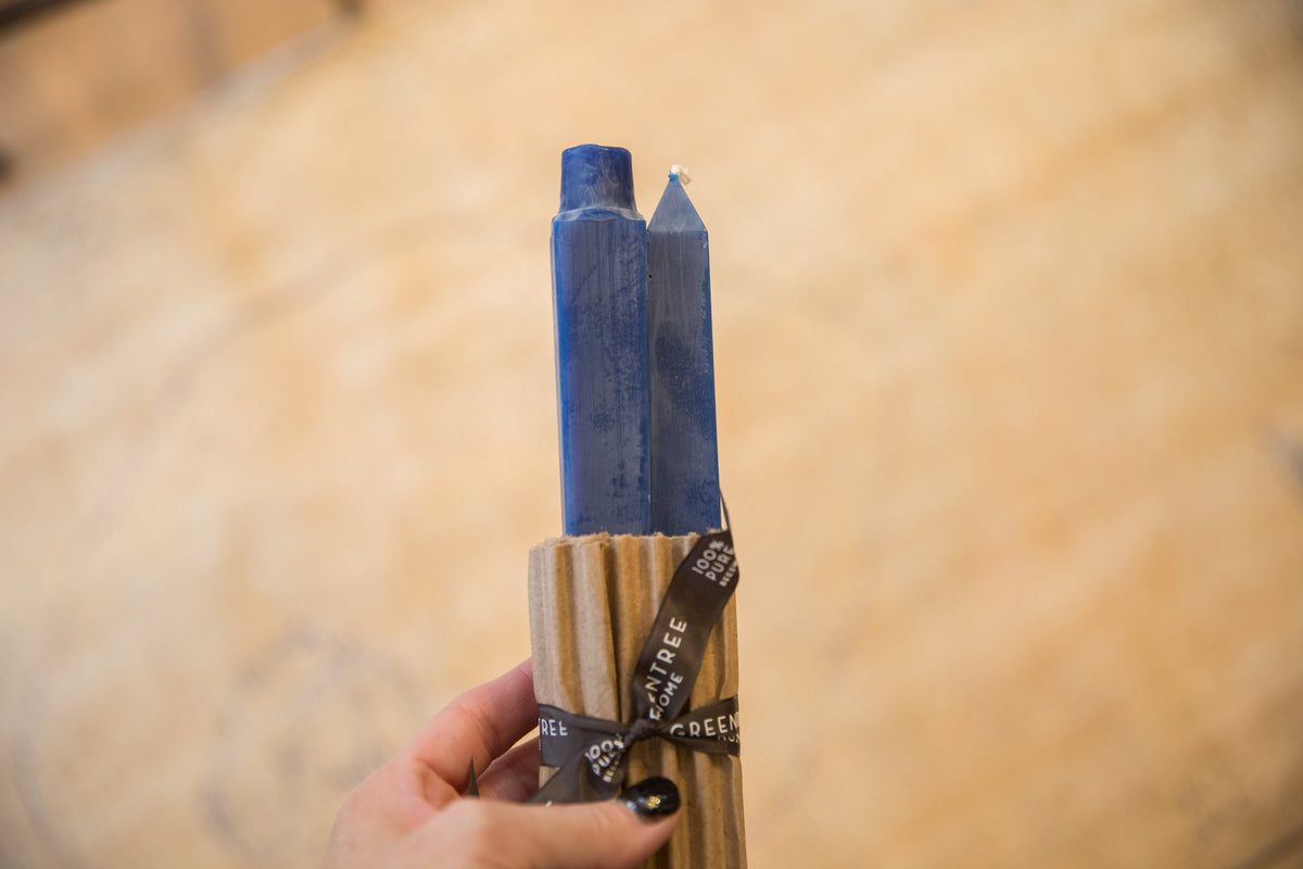 Pair of cobalt blue square beeswax taper candles in corrugated wrap with ribbon.