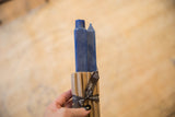 Pair of cobalt blue square beeswax taper candles in corrugated wrap with ribbon.