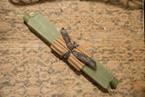 Pair of sage green square beeswax taper candles, tied with a Greentree Home ribbon.