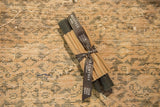 Pair of Greentree Home 6 inch antique-colored beeswax taper candles, ribbon-wrapped.