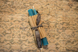 Greentree Home 6 inch turquoise beeswax taper candles, wrapped in corrugated paper.