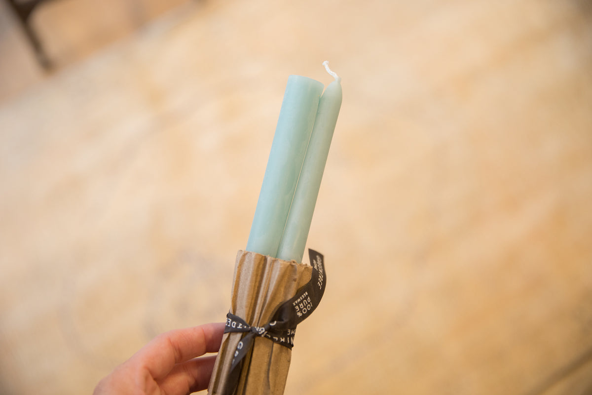 Pair of Robin's Egg Blue beeswax taper candles in ribbed paper packaging.