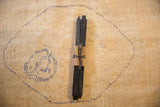 Black square beeswax taper candles bundled with ribbed paper and ribbon.