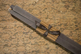 Gray square taper beeswax candles bundled with corrugated paper and a Greentree Home ribbon.