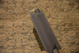 Gray square beeswax taper candle, highlighting its smooth texture and wick.