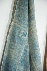 Hand-mended detail and frayed edge on the vintage denim indigo African textile.