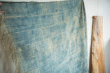 Hand-woven vintage African indigo textile with denim blue stripes and subtle split.