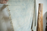 Faded denim indigo African textile with handwoven texture and visible stitch details.