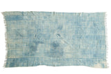 Hand-woven African indigo textile featuring time-softened denim blue hues and natural striped pattern.