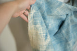 Hand-woven texture of a vintage indigo African textile, with variegated blue and off-white dye.