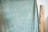 Supple hand woven denim indigo textile with nuanced color shifts and subtle horizontal weave.