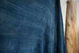Hand woven denim indigo African textile, showcasing its rich color and linear cotton texture.