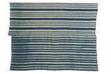 Collector hand-dyed African indigo textile with varied blue and pale stripes.