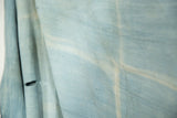 Hand-woven denim indigo African textile with natural striations and visible split.