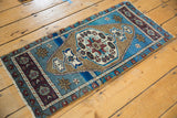 Vintage distressed Oushak rug mat corner with aubergine border, aqua blue field, and abrashes.