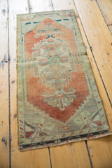 Textured low pile vintage Oushak rug, showing terracotta, mint, and ivory tones.