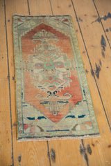 Distressed vintage Oushak rug with low pile, stepped contour, terracotta, ivory, sapphire accents.