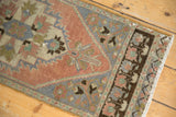 Distressed Oushak runner's dusty rose field, oxidized silver, and chocolate geometric motifs.