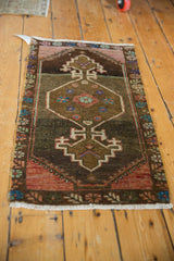 Distressed vintage Oushak rug with a diamond medallion, rich brown, brick red, and ivory colors.