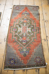 Distressed Oushak rug with brick red medallion, bronze, and oxidized silver motifs.