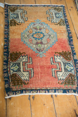 Close-up of distressed vintage Oushak rug, with serrated medallion, abrashed terracotta, and pile wear.