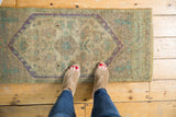 Distressed Oushak rug runner, muted beige and pale mauve, showing worn knot heads.