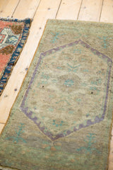 Distressed vintage Oushak rug showing even wear, faint foundation, pale mauve and beige floral medallion.