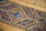 Close-up of distressed Turkish Oushak runner pile with even wear and geometric navy, chestnut, bronze patterns.