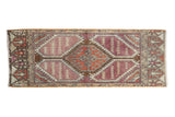 Distressed Oushak runner with faded aubergine, rust, and ivory geometric medallions, 1'3