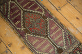 Worn pile and serrated medallion of a distressed Oushak rug mat runner, rust and aubergine.