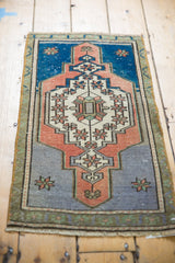 Distressed vintage Oushak rug with worn pile, fringe, terracotta, and slate blue.