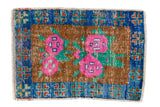 Distressed vintage Oushak mat, bright pink florals on copper, sapphire blue border. 1'11