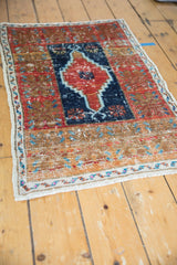 Vintage Distressed Oushak rug with stepped navy medallion, cherry red field, and noticeable wear.