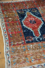 Distressed Oushak rug with cherry red, navy stepped medallion and banded border detail.