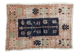 Vintage distressed Oushak rug with navy tree of life, pale terracotta, green, ivory florals.