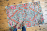 Vintage distressed Oushak rug: slate blue medallion, tangerine border, pink serpent motifs.