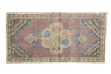 Distressed Oushak runner with scalloped medallion, dusty mauve, ivory, and checker spandrels.