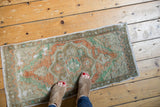 Distressed Turkish Oushak rug with even wear to knot heads, terracotta, mint, ivory.