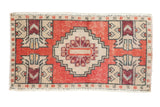 Vintage Distressed Oushak rug mat with a pale cherry red stepped medallion and ivory geometric motifs.
