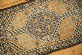 Distressed Oushak rug close-up: worn geometric medallion, burnt orange, and silver tones.