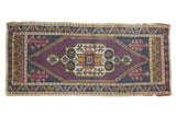 Vintage distressed Oushak mat with purple geometric medallion, navy, gold, and red floral motifs, 1'9