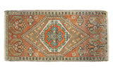Distressed vintage Oushak runner with a central geometric medallion, burnt orange, ivory, and mint.