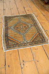 Distressed Oushak rug corner with pale burnt orange, beige serrated geometric pattern.