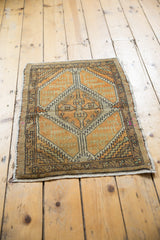 Geometric dark border and secured fringe on a distressed Oushak rug corner.