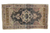 Vintage Distressed Oushak rug with ornate floral medallion, dark field, mauve, and ivory, 2x3.